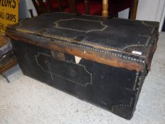 A 19th Century leather bound and brass studded trunk opening to reveal a wallpaper lined interior
