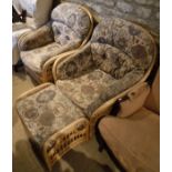 A pair of modern conservatory chairs with geometric patterned upholstery and matching footstool,