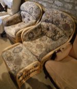 A pair of modern conservatory chairs with geometric patterned upholstery and matching footstool,