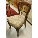 A set of five Victorian oak framed balloon back dining chairs with multi-coloured upholstery,