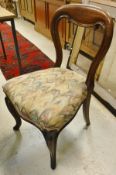 A set of five Victorian oak framed balloon back dining chairs with multi-coloured upholstery,