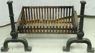 A modern wrought iron fire basket and a pair of fire dogs in the Gothic Revival style,