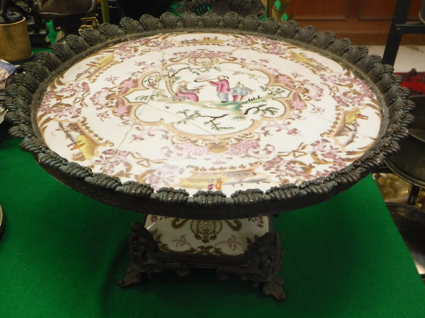 A Chinese famille-rose tazza, the centre field decorated with figures, one smoking a pipe,