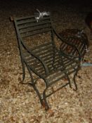 A pair of wrought iron slatted chairs and small table