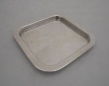 A modern silver pin dish of square form,