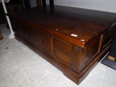 A modern Indian hardwood coffee table with side drawers,
