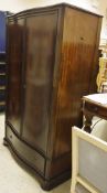 A modern mahogany serpentine fronted wardrobe in the Louis Philippe taste,