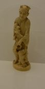 A Japanese Meiji period carved ivory okimono as a man with branch of peaches in his right hand,