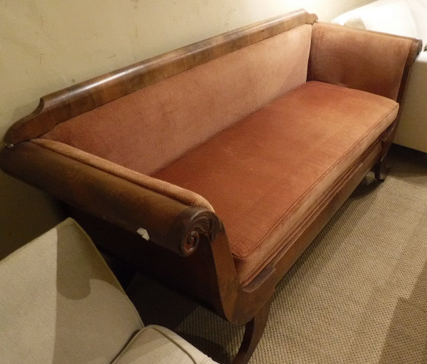 A Biedermeier style sofa in red upholstery with applied scrolling mouldings to the arms