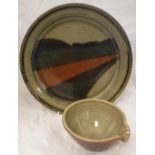 A John Leach Studio Pottery plate on a beige ground with brown red and brown striped flash,