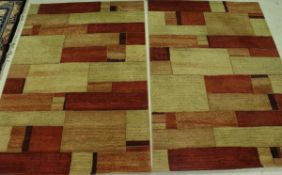 Two modern rugs of yellow, red and terracotta etc colours in an abstract square pattern,