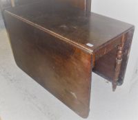 An early Victorian mahogany drop-leaf dining table on turned supports