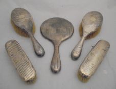 A silver-backed dressing table brush set,