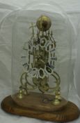 A brass skeleton clock with single fusee movement, the chapter ring with painted Roman numerals,