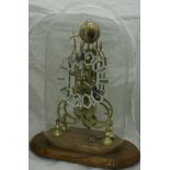 A brass skeleton clock with single fusee movement, the chapter ring with painted Roman numerals,