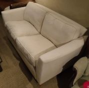 A modern Wesley Barrell two seat sofa with cream upholstery,