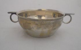 A George V silver porringer of plain form with two lug handles inscribed "Angela Neale 26th January