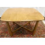 An Ercol elm coffee table, the rounded rectangular top on moulded supports,