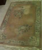 A Chinese superwash carpet with central floral medallion on a cream ground within a cream and pink