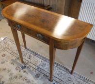 A walnut and cross-banded demi-lune single drawer side table in the 19th Century manner