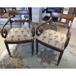 A pair of George III mahogany elbow chairs with bar back and scroll arms above upholstered seats