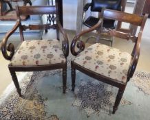 A pair of George III mahogany elbow chairs with bar back and scroll arms above upholstered seats