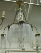 An early to mid 20th Century gilt brass and glass drop electrolier in the style of Hector Guimard,