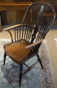 A 19th Century Windsor wheel and stick back chair on turned legs united by an H stretcher (with