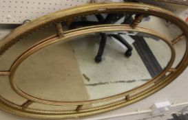 An oval multi-plate wall mirror,