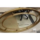 An oval multi-plate wall mirror,