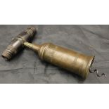 A 19th Century brass corkscrew, the cylinder with ringed decoration and domed shoulders,