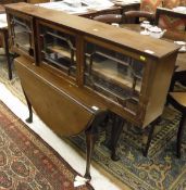 A late George III mahogany oval drop-leaf dining table on cabriole legs to pad feet,