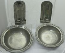 A pair of modern pewter candle sconces and a pair of Cosi Tabblini "Tudor Rose" shaped dishes