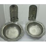 A pair of modern pewter candle sconces and a pair of Cosi Tabblini "Tudor Rose" shaped dishes