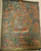 An early 20th Century Tibetan thangka depicting Green Tara upon a lotus seat within a border of