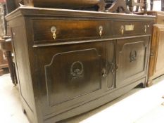 A 1920's oak sideboard and a Continental stained pine side cabinet