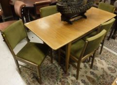 A Gordon Russell walnut dining room suite comprising table,