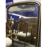 A Victorian arch top overmantle mirror in an ebonised and gilt frame