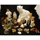 A collection of Lomonsov porcelain figures including child with book and flower, large polar bear,