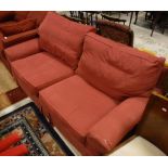 A two seat sofabed in red upholstery