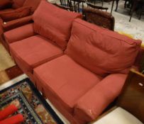 A two seat sofabed in red upholstery