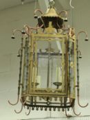 A painted metal hall lantern in the Regency style with faux bamboo column and bell decoration
