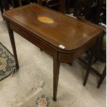 A 19th Century mahogany and inlaid rounded rectangular fold-over card table on square tapered legs