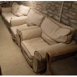 A modern three piece suite comprising three seat sofa and two single chairs in oatmeal upholstery