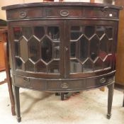 A mahogany bow fronted glazed corner display cabinet,