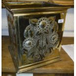 An brass embossed planter in the Arts & Crafts manner of Christiopher Dresser with flower and vine