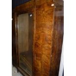 An early 20th Century burr yew bookcase cabinet in the Biedermeier style,