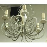 A modern cream painted wrought iron and wooden six branch electrolier with scroll work decoration