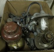 A box containing a collection of castors and four various lamps