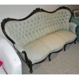 A Victorian three seat sofa in pale green button back upholstery,